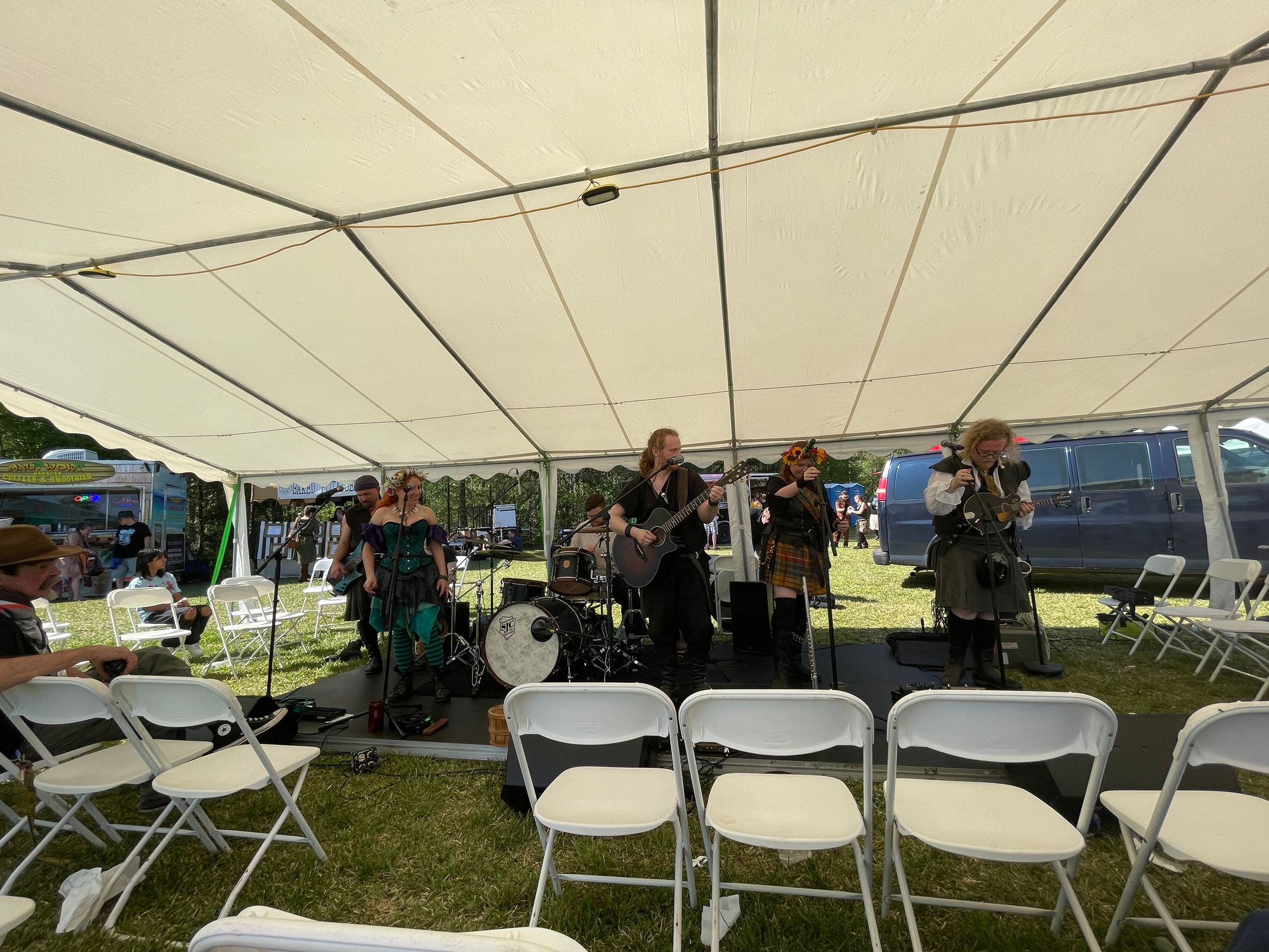 Six members of a band in medieval clothing playing music.