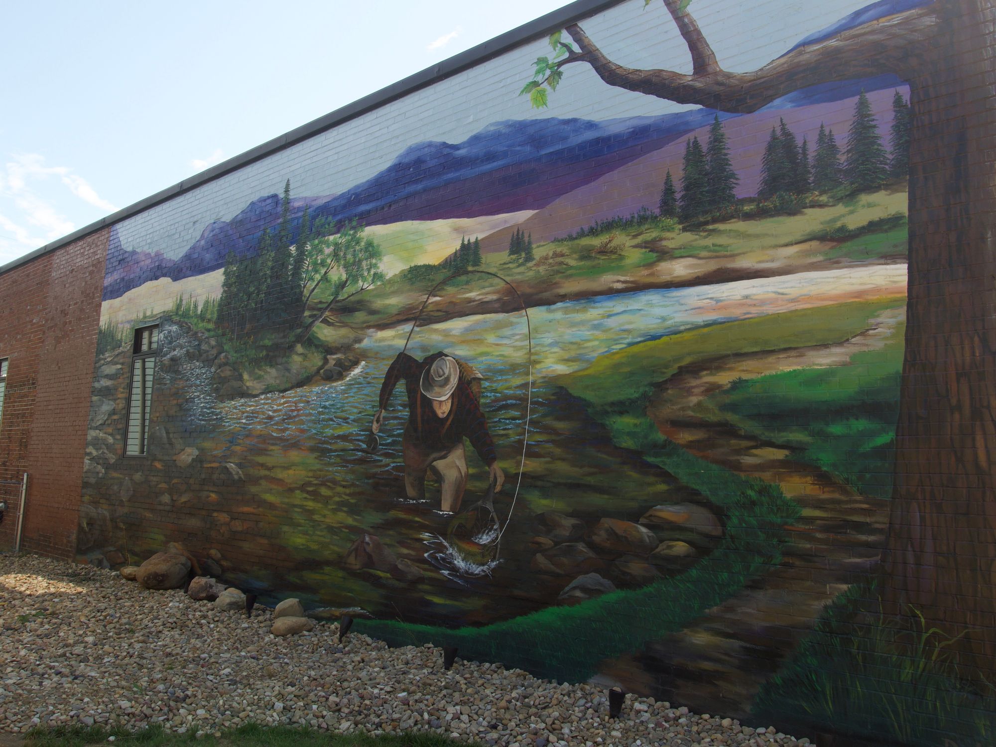 A mural of a fly fisher.